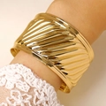 Macro shot of gold ribbed cuff bracelet with textured geometric design and spiral pattern - Spiral Textured Wide Open Bangle (5414) / Gold