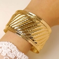 Detail of wide gold cuff bracelet featuring hammered texture and vintage stripes - Vintage Hammered Twill Wide Bangle (4140) / Gold