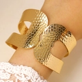 Close-up of golden wide open cuff bracelet with irregular hammered texture and cut-out detail - Honeycomb Hammered Hollow Wide Bangle (5001) / Gold