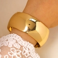 Close-up of minimalist gold wide cuff bracelet with mirror finish on model with lace sleeve - Minimalist Wide Mirror Bangle (5443) / Gold