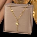 18K gold plated titanium steel necklace with flower charms and tassel drop detail - Clover Tassel (H228) Gold