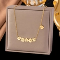 Elegant 18K gold-plated stainless steel necklace with delicate daisy charms on a display box - Daisy Necklace (H6183) Gold