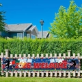 Outdoor 2026 soccer tournament banner with 2026 WELCOME text and global flags on a fence - 30x120cm (Punched with Rope)