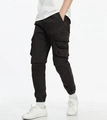 Detail view of cargo jogger pants showing side flap pockets and elastic cuffs in black - EU 29 / Black