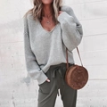 Detail of grey V-neck oversized knit sweater showing thick texture and ribbed cuffs - Light Gray