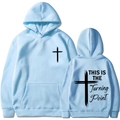 Detail of light blue hoodie showing the This is the Turning Point print and cross logo - Light Blue