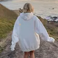 Outdoor back view of a white oversized hoodie featuring drop shoulders and a relaxed fit - S / White with Yellow Text