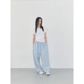 Women's baggy light blue sweatpants with drawstring waist paired with a white tee - Light Blue