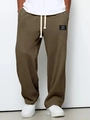 Close-up of olive waffle knit trousers showing elastic waistband with white drawstrings - S / Brown