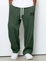 Detail of dark green waffle knit texture pants with white drawstring and woven patch - S / Dark Green