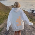 White oversized hoodie with orange Do What Makes You Happy back print on coast - S / Tops / White with Yellow Letters