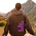 Brown hooded sweatshirt with Do What Makes You Happy slogan on back against sunset - S / Tops / Coffee with Purple Lettering