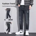 Slim fit men's deep blue washed denim jeans with stylish white graphic print on leg - EU 28 / Black