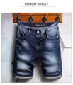 Detailed shot of men's washed denim shorts with vintage whiskers and cuffed hems - EU 38 / Dark Blue