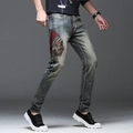 Men's slim-fit punk denim jeans featuring vibrant Native American chief embroidery details - EU 28 / Blue
