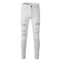 Detail view of distressed white slim jeans featuring silver sequin patches and ripped texture - EU 30 / White