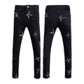 Detail of slim-fit black denim jeans featuring white cross star and paint splatter prints - EU 28 / Black Star Splatter Style