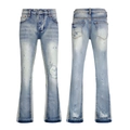 Detail view of light blue flared jeans featuring paint splatters and distressed ripped denim - 63617 / EU 38