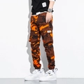 Detail of cargo pockets and camouflage print on slim fit men's jogger trousers - M / Red Camouflage