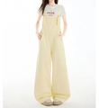 Detail shot of light yellow loose denim overalls with front pocket and straight leg design - XS / Milk Yellow