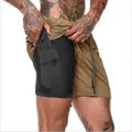 Detail of 2-in-1 men's running shorts showing hidden inner pocket for mobile phone - M / Bottoms / Khaki
