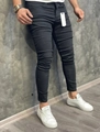 Men's black skinny fit denim jeans shown on model in a minimalist industrial setting - S / Black