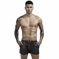 Detail of men's black athletic shorts featuring red drawstrings and side stripe accents - M / Black