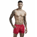 Close-up of red quick-dry swim shorts featuring drawstring waist and tricolor stripe detail - M / Red