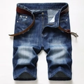 Detail of vintage denim texture, faded whiskering, and zipper fly with a metal button - EU 28 / Blue (389)