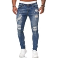 Jeans slim da uomo blu medio con dettagli strappati e baffature stile street wear - Blu