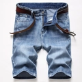 Flat lay of light blue washed denim shorts with a brown leather belt and metal button details - EU 28 / Light Blue (389-1)
