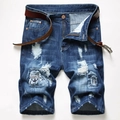 Detail view of men's blue distressed denim shorts with ethnic woven patches and brown belt - EU 28 / Blue (390)