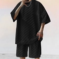 Detail view of men's black two-piece set featuring 3D waffle texture fabric and relaxed fit - S / Black