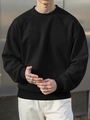 Macro shot of black crewneck sweatshirt featuring raglan sleeves and ribbed cuffs details - S / Black