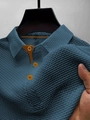 Close-up of navy blue polo shirt with waffle texture and brown contrast collar buttons - Denim Blue