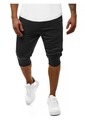 Dettaglio dei pantaloncini sportivi neri da uomo con polsini elastici e tessuto a maglia - M / Nero