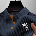 Detail of navy waffle knit polo shirt with orange contrast collar and palm tree print - S / Navy Blue