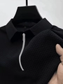 Dettaglio polo nera in tessuto a nido d'ape con cerniera argentata ed etichetta XXL - Taglia S / Top / Nero