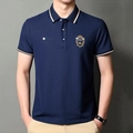 Detailed view of navy blue polo shirt featuring crown embroidery and PO-78 chest prints - Navy Blue