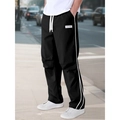 Black paratrooper pants with white side stripes and drawstring waist for urban sportswear - S / Black
