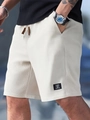 Detail of white waffle knit texture and drawstring waist on men's casual shorts - S / Off White