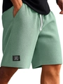 Dettaglio dei pantaloncini verdi in tessuto nido d'ape con coulisse e etichetta nera - Taglia M / Verde chiaro