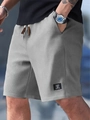 Macro shot of grey waffle knit shorts featuring a drawstring waist and textured fabric - S / Gray