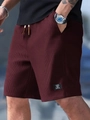 Detailed macro view of men's burgundy waffle knit shorts with drawstring and texture - S / Burgundy