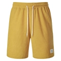 Detail of yellow corduroy shorts with elastic drawstring waist and sports logo patch - Yellow
