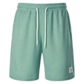 Detail view of mint green corduroy shorts showing elastic waist, drawstring, and sports label - Green