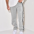 Close-up of men's grey knit trousers featuring black side stripes and functional snap buttons - Light Gray