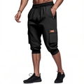 Detail of black heavy cargo shorts showing elastic drawstring waist and side flap pocket - Black