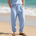Detail of light blue linen jogger pants with elastic waist and white drawstring on beach - S / Bottoms / Light Blue
