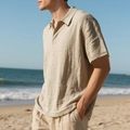 Detail of breathable waffle texture on men's beige linen polo shirt with beach scenery - Khaki